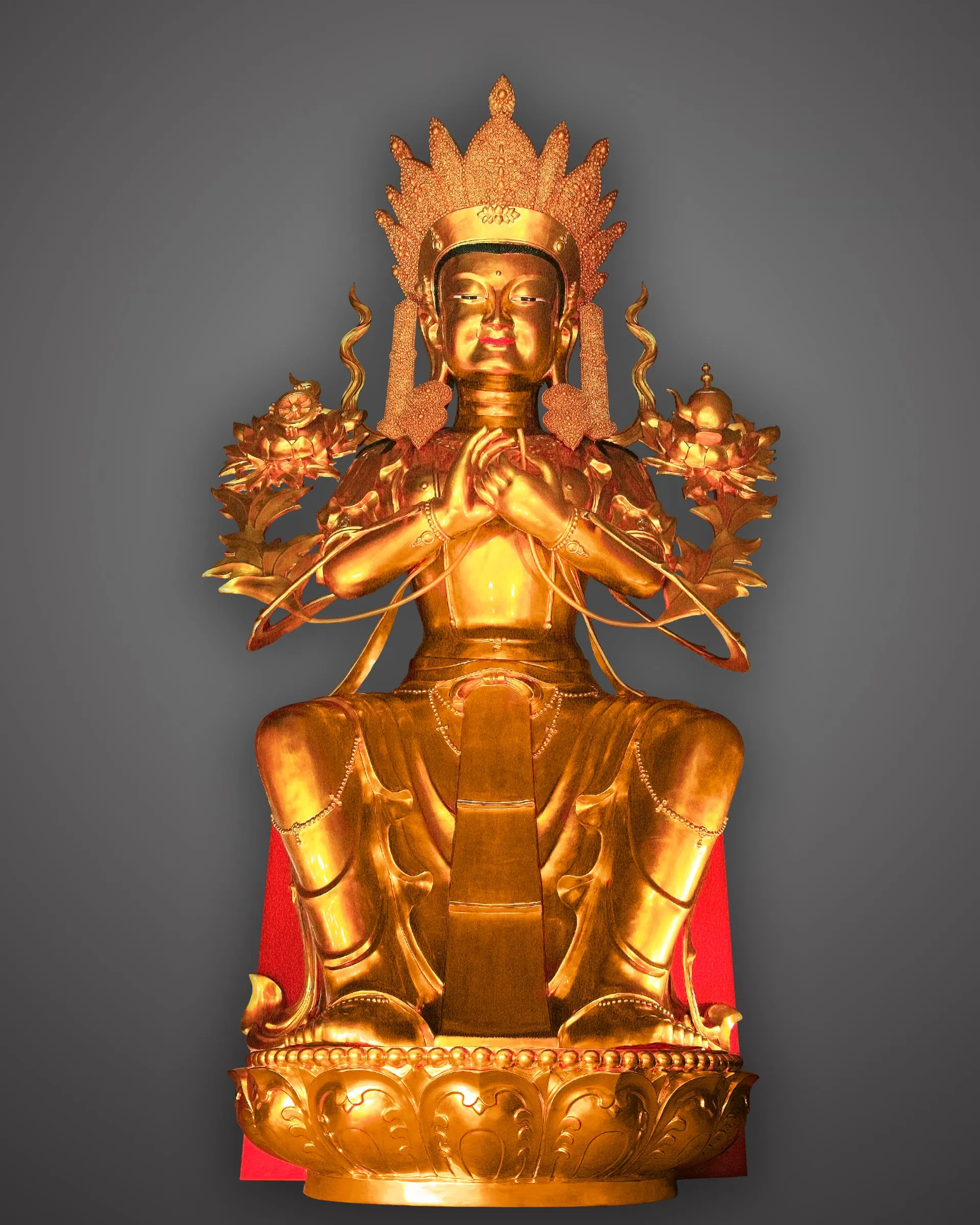 Gilded crowned Maitreya seated with hands joined at the chest.