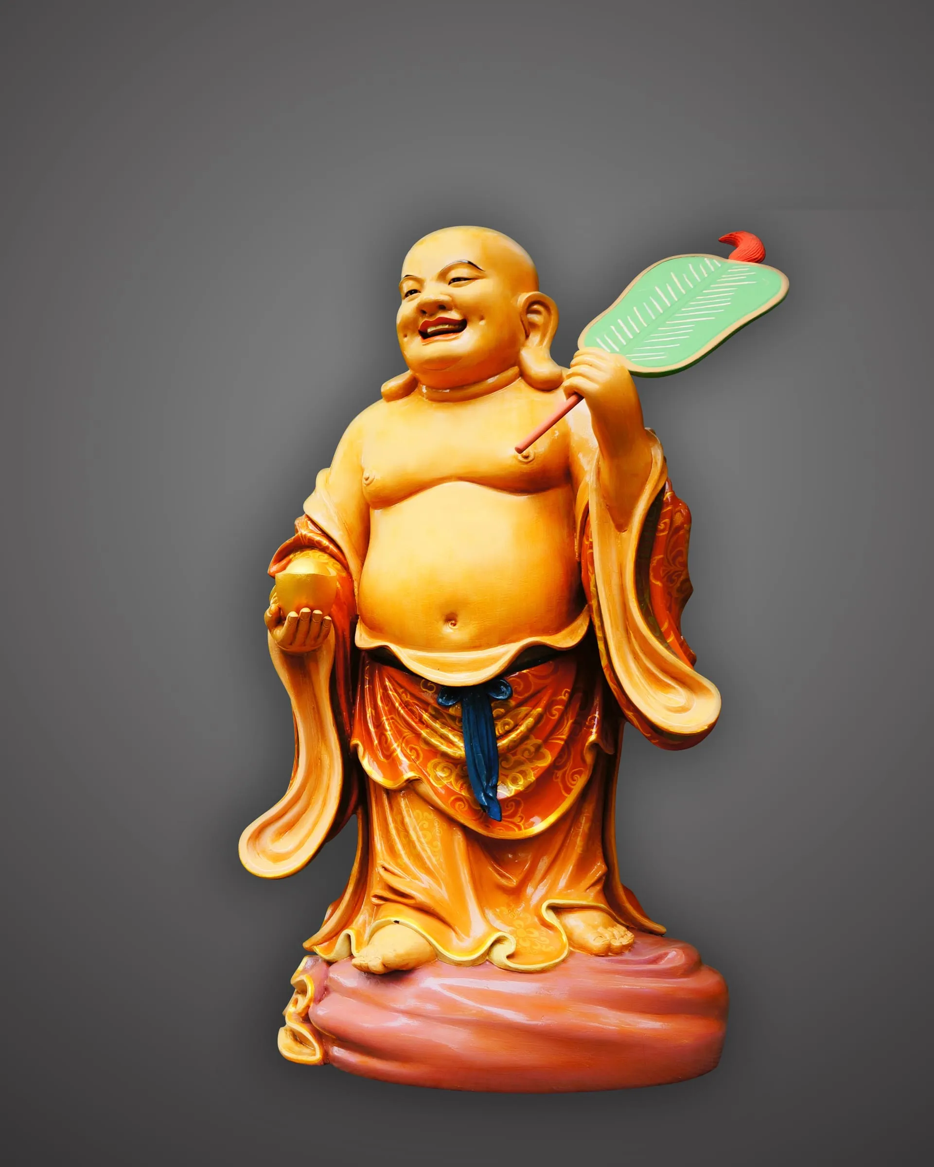 Laughing Maitreya, gilded, holding a fan, in a painted robe.